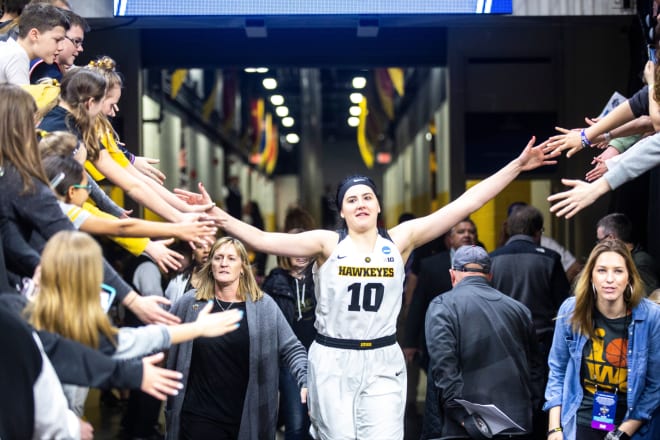 Megan Gustafson celebrates with Iowa fans. 