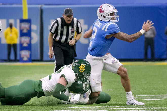 Matt Corral is tackled by the Baylor defenders. 