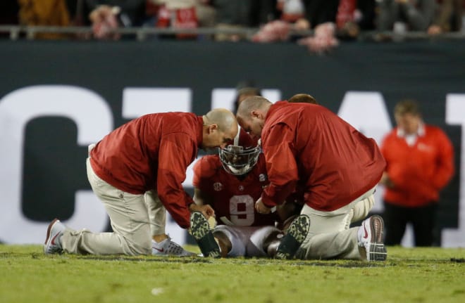 Trainers attend to Alabama running back Bo Scarbrough (9) after he was injured during Clemson's 35-31 victory over Alabama in the College Football Playoff National Championship game in Raymond James Stadium in Tampa Monday, January 9, 2017. 