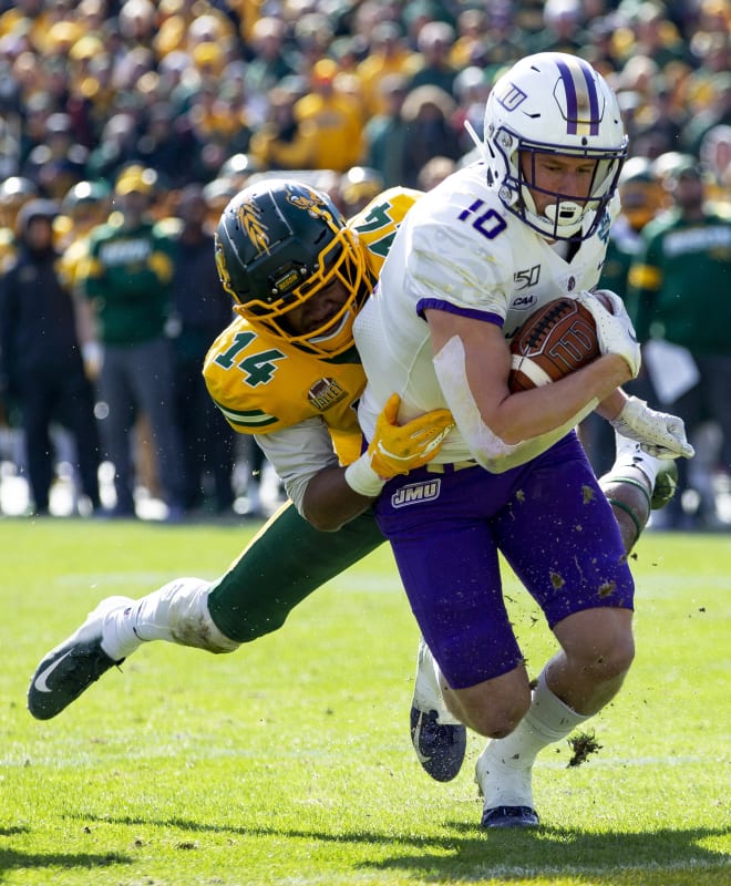 James Madison wide receiver Riley Stapleton (10) runs after a catch as a defender tries to pull him to the turf during the Dukes' FCS championship game loss to North Dakota State last month at Toyota Stadium in Frisco, Texas.