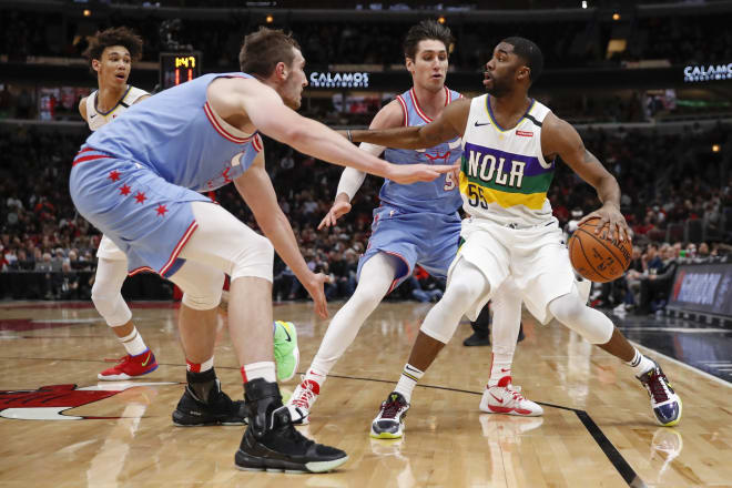 ew Orleans Pelicans guard E'Twaun Moore (55) is defended by Chicago Bulls forward Luke Kornet (2) during the second half at United Center.