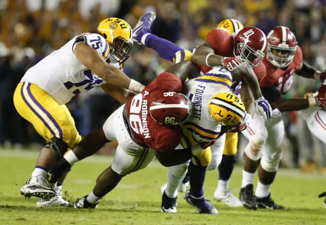 LSU running back (7) Leonard Fournette is stopped and brought down by Alabama defensive lineman (86) AÕShawn Robinson and Alabama linebacker (10) Reuben Foster during Bama's 30-16 victory over LSU in Bryant-Denny Stadium in 2015.