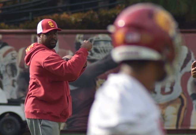 New USC defensive backs coach Greg Burns instructing his players at spring practice Tuesday. 