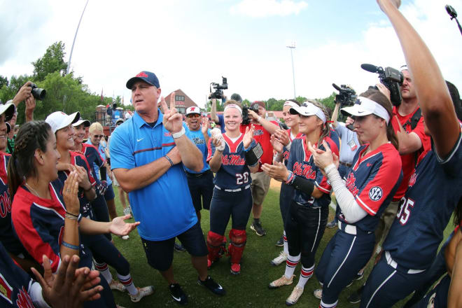 Ole Miss coach Mike Smith celebrates with his team after defeating North Carolina Sunday to advance to next weekend's super regionals at UCLA.