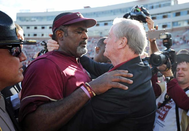 FSU President John Thrasher shares an embrace with interim head coach Odell Haggins after Saturday's win over ULM.