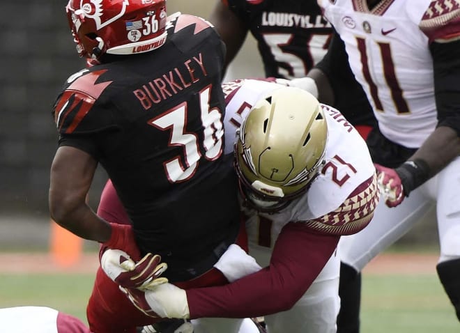 Florida State's Marvin Wilson wraps a Louisville ballcarrier Saturday.