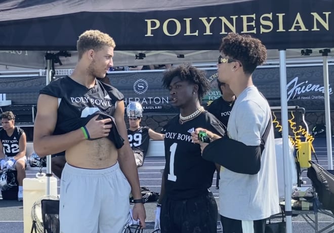 Unsigned five-star tight end Duce Robinson, left, talks with USC five-star freshmen WR Zachariah Branch and QB Malachi Nelson on Thursday during Polynesian Bowl practice.