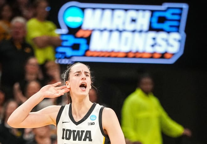 Caitlin Clark gestures to the crowd in the final seconds of Iowa's win over West Virginia Monday night. 