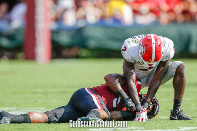 Rico Dowdle is slow to get up after a big hit from Georgia's Richard Lecounte.