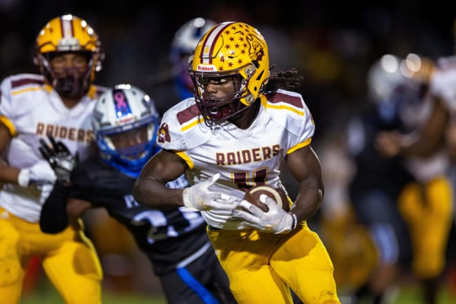 Glades Central running back Semaj Demps runs the ball against Pakokee during the Muck Bowl in Pahokee, Florida on November 6, 2021.