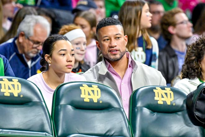 Notre Dame head football coach Marcus Freeman (right) and daughter Siena take in the Notre Dame women's basketball win on Sunday.