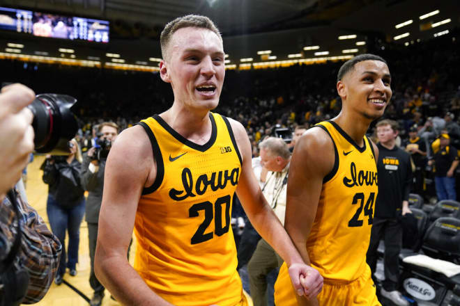 Payton Sandfort and Kris Murray celebrate Iowa's 93-84 (OT) comeback win over Michigan