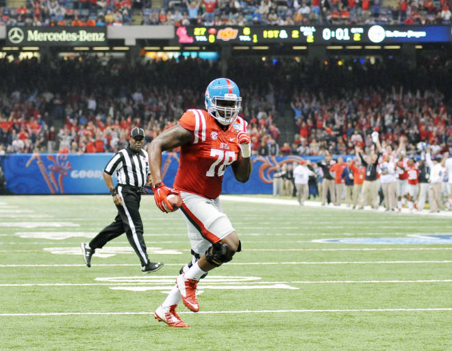 Ole Miss offensive tackle Laremy Tunsil scores on a TD reception Friday night in the Rebels' 48-20 win over Oklahoma State in the Allstate Sugar Bowl. Tunsil declared for the NFL draft on Monday, bypassing his senior season at Ole Miss.