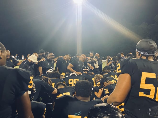 Head Coach Loren Johnson leads his team in prayer following their 48-7 victory over Manchester 9/1/22