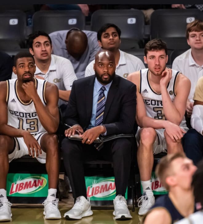 Curtis Haywood and Evan Cole flank West on the Jackets' bench