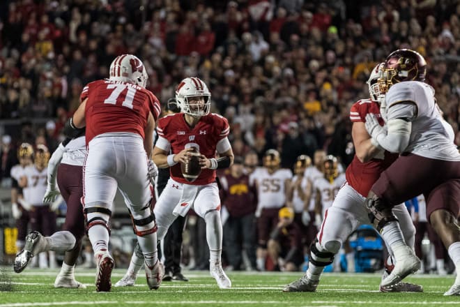 Chase Wolf attempts a pass on the final drive. Riley Mahlman (71) was called for holding, one of four penalties on the drive.