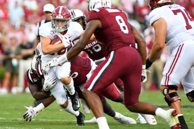 Alabama's Slade Bolden, left, evades South Carolina defenders to pick up a first down for the Crimson Tide. Photo | Getty Images