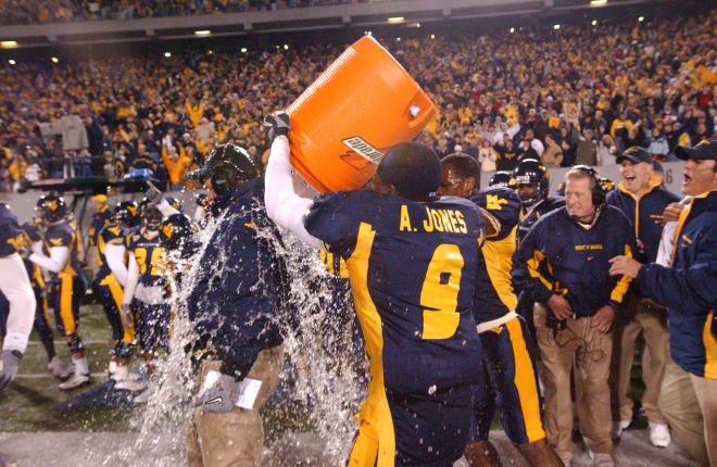 Head coach Rich Rodriguez receives the traditional Gatorade bath from cornerback Adam "Pacman" Jones and an unknown Mountaineer.