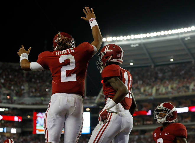 Alabama quarterback Jalen Hurts celebrates with receiver Henry Ruggs III (11) after hitting him for a touchdown against Arkansas. Photo | Getty Images