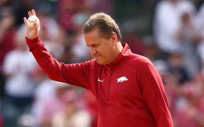 Arkansas head coach John Calipari prior to throwing out the first pitch Saturday at Baum-Walker Stadium in Fayetteville.