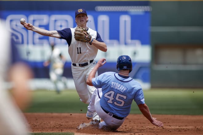 Notre Dame second baseman Jack Penney throws to first base after getting a forceout at second.