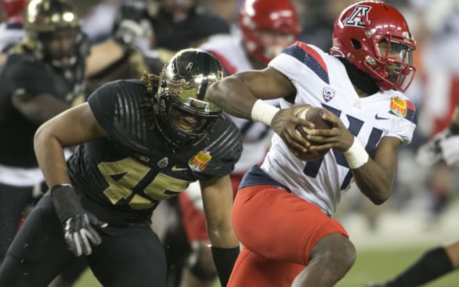 Austin Larkin chases Khalil Tate, one of the few times — maybe the only time — the Wildcat QB broke containment. 