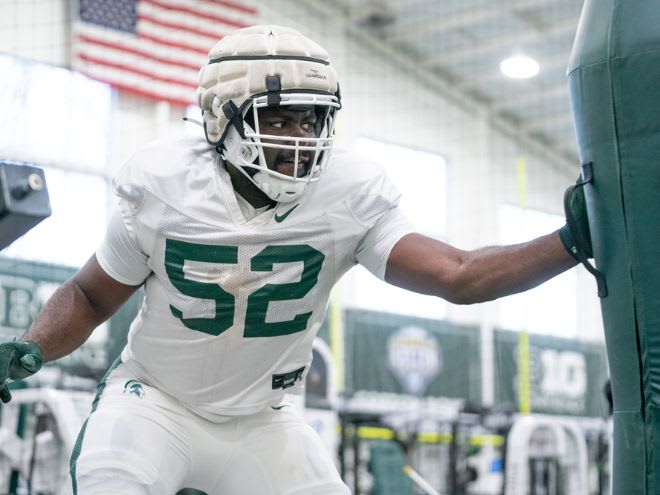 Michigan State defensive lineman Tunmise Adeleye goes through drills at spring practice