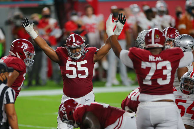 Alabama offensive linemen Emil Ekiyor Jr. (55) and Evan Neal (73) celebrate a touchdown against Ohio State in the national championship game. Photo | Getty Images 