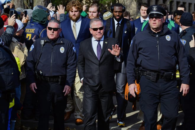 Brian Kelly walking into Notre Dame Stadium before his team's matchup with Navy (Photos by Andris Visocks)
