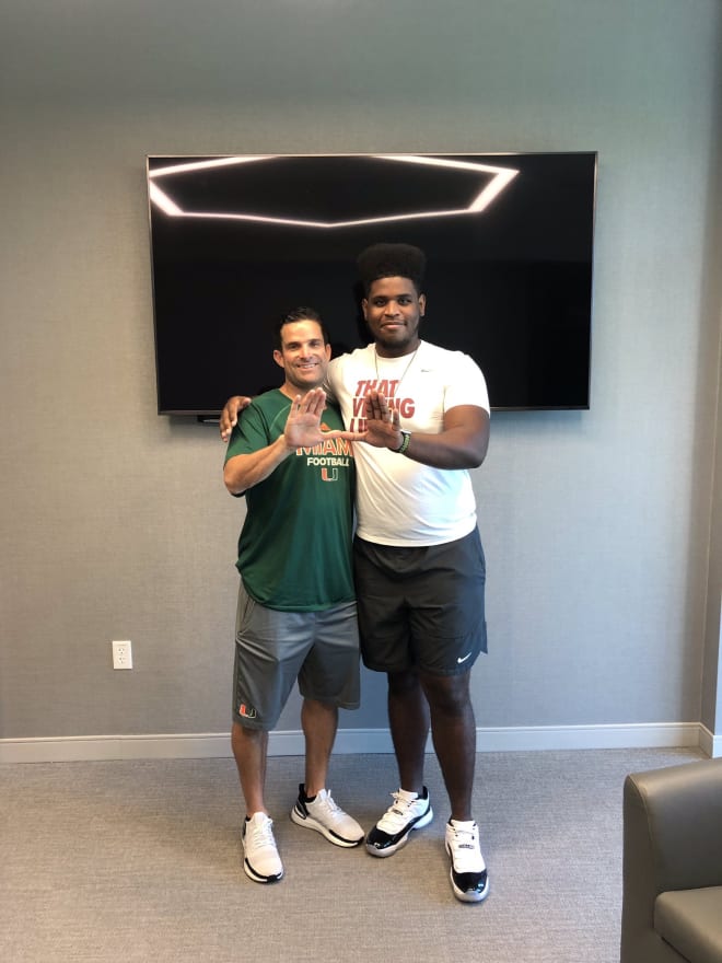 Walker took photos Tuesday, including this one with Manny Diaz
