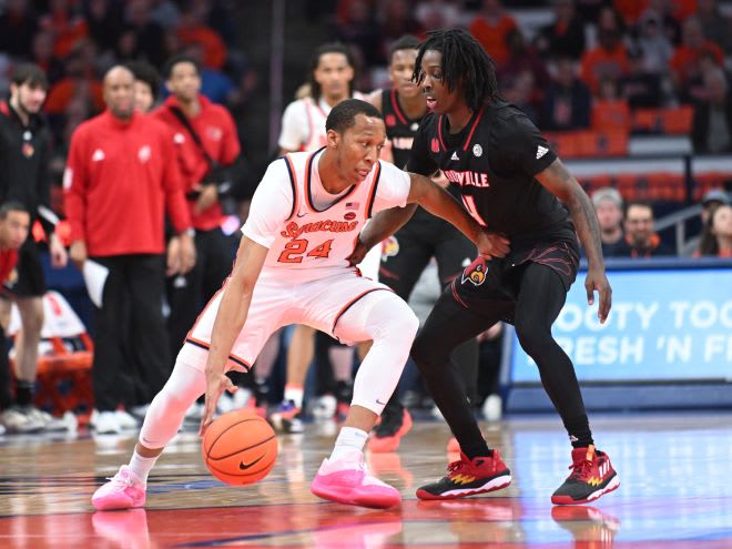 Feb 7, 2024; Syracuse, New York, USA; Syracuse Orange guard Quadir Copeland (24) tries to dribble past Louisville Cardinals guard Ty-Laur Johnson (4) in the first half at the JMA Wireless Dome. Mandatory Credit: Mark Konezny-USA TODAY Sports