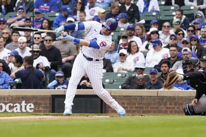 Chicago Cubs left fielder Ian Happ (8) hits a single against the Miami Marlins during the first inning at Wrigley Field. Mandatory Credit: David Banks-USA TODAY Sports