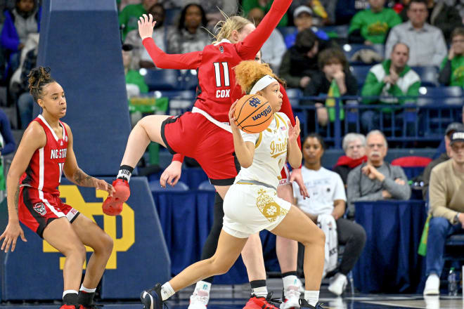 NC State's Maddie Cox (11) defends as Notre Dame guard Hannah Hidalgo (3) looks to make a pass.