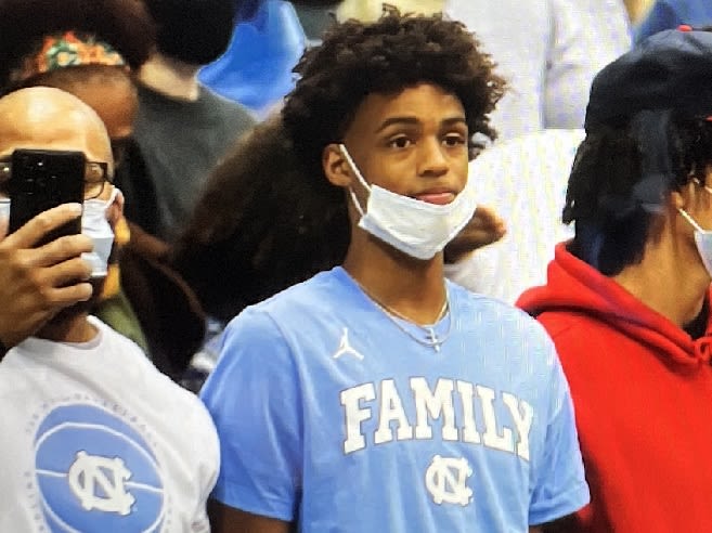 Cam Scott and his father sat righ behind UNC's bench on Saturtday night.