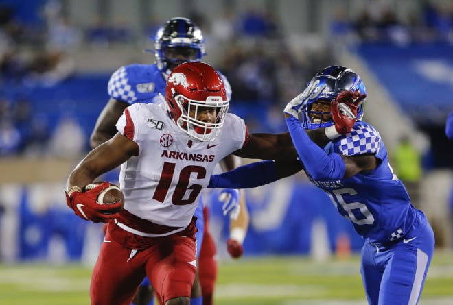 Arkansas receiver Treylon Burks delivering a stiff-arm against Kentucky.