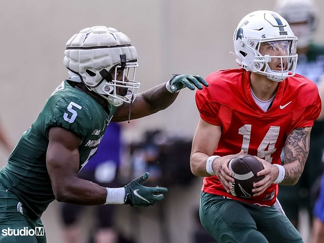 Junior quarterback Noah Kim hands the ball to UConn transfer running back Nate Carter