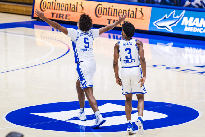 Jaemyn Brakefield and Jeremy Roach celebrate Duke's win.