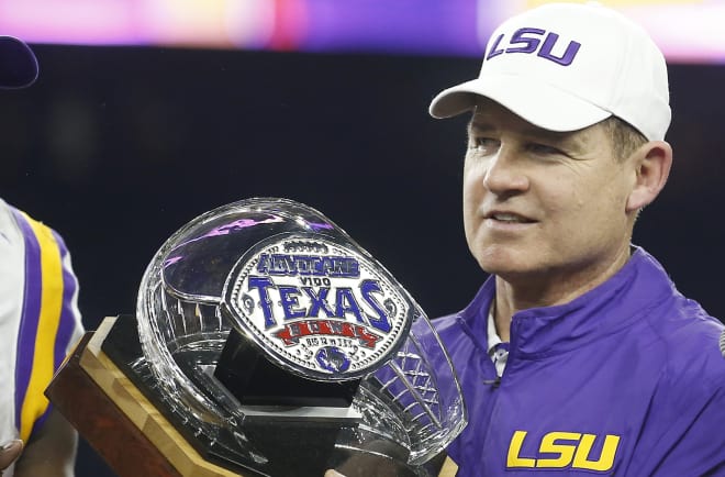 LSU Tigers head coach Les Miles holds the Texas Bowl trophy after his Tigers defeated the Texas Tech Red Raiders 56-27