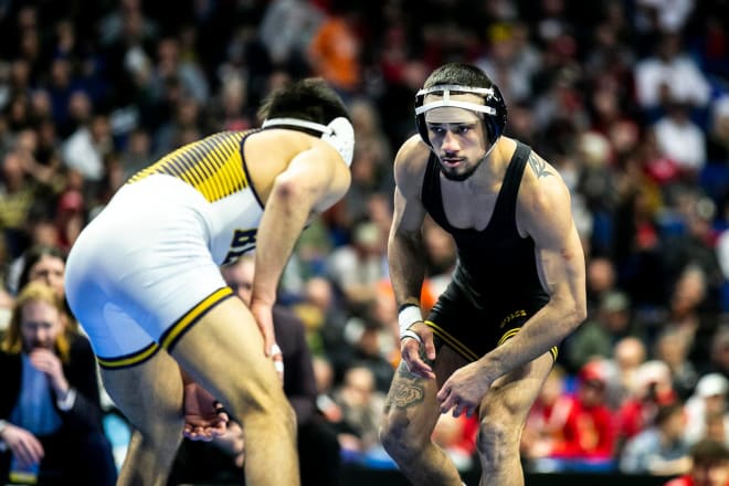 Iowa's Real Woods circles Northern Colorado's Andrew Alirez in the 141 lb final at the NCAA Tournament.