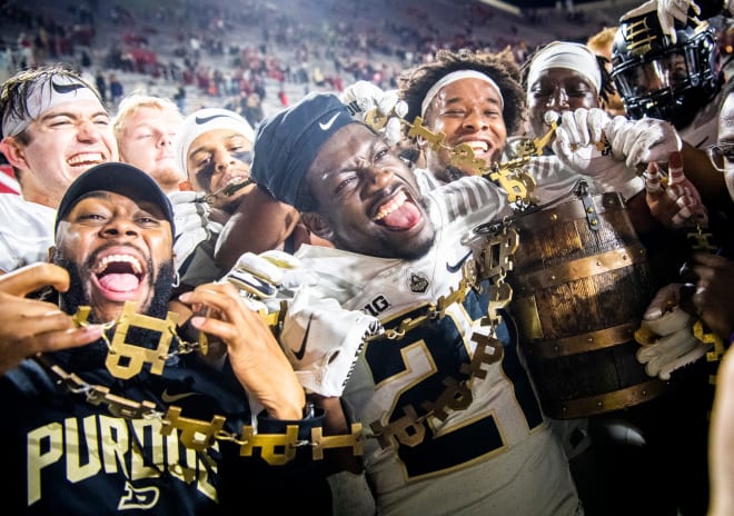 Purdue's Sanoussi Kane (21) and the Boilermakers celebrate with the Old Oaken Bucket after the Indiana versus Purdue football game at Memorial Stadium on Saturday, Nov. 26, 2022.