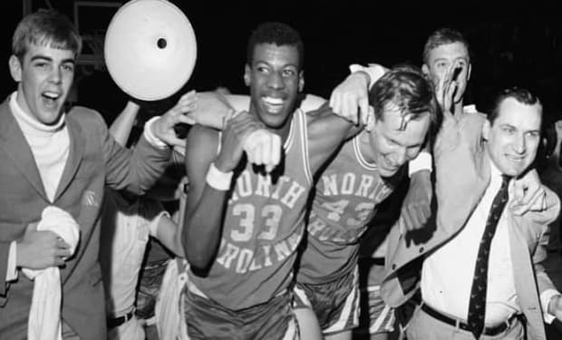 Charlie Scott, Dean Smith and the Tar Heels celebrate winning the 1969 East Regional and spot in the Final Four. 