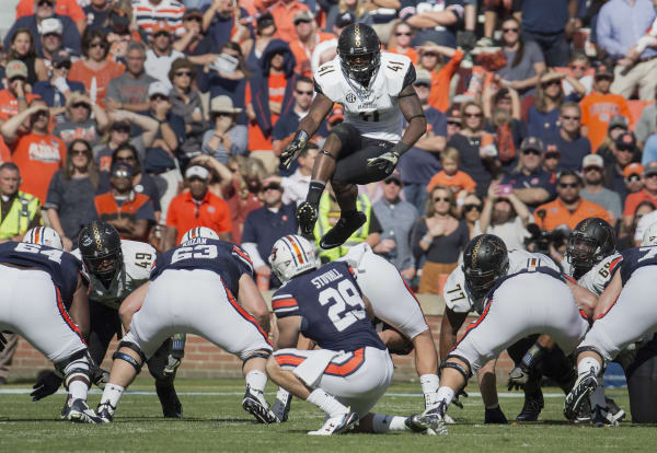 Zach Cunningham (leaping) is one of the greatest football players in Vanderbilt history.