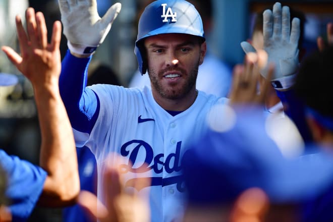 Los Angeles Dodgers first baseman Freddie Freeman (5) is greeted after hitting a solo home run against the San Diego Padres during the first inning at Dodger Stadium. Mandatory Credit: Gary A. Vasquez-USA TODAY Sports