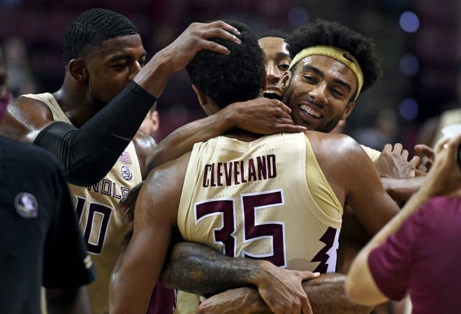 FSU players celebrate with freshman guard Matthew Cleveland on Wednesday night.