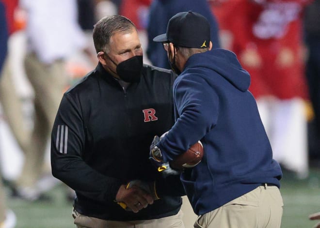 Rutgers Scarlet Knights head coach Greg Schiano falls to 0-1 against Michigan Wolverines head football coach Jim Harbaugh.