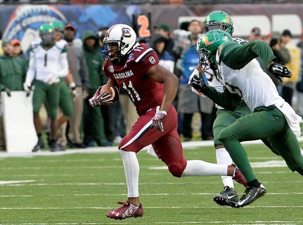 Pharoh Cooper is chased by a Miami defender in the 2014 Duck Commander Independence Bowl. 