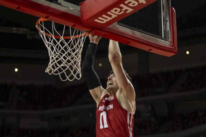 Wisconsin forward Micah Potter (11) makes a dunk against Nebraska during the first half. Potter finished with 15 points.