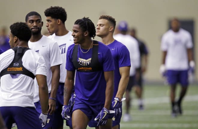 Washington defensive back Jordan Miller smiles as he begins a drill at the team's first official NCAA college football practice of the year Monday, July 31, 2017, in Seattle. (AP Photo/Elaine Thompson)