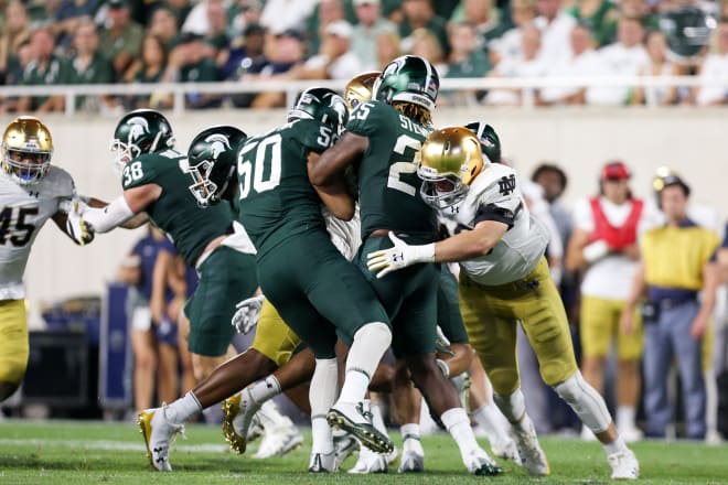 Linebacker Greer Martini making a tackle against Michigan State.