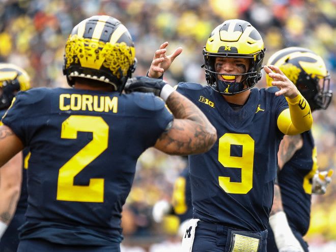 Michigan quarterback J.J. McCarthy (No. 9) and running back Blake Corum (No. 2) celebrate a touchdown against Indiana on Oct. 14, 2023.